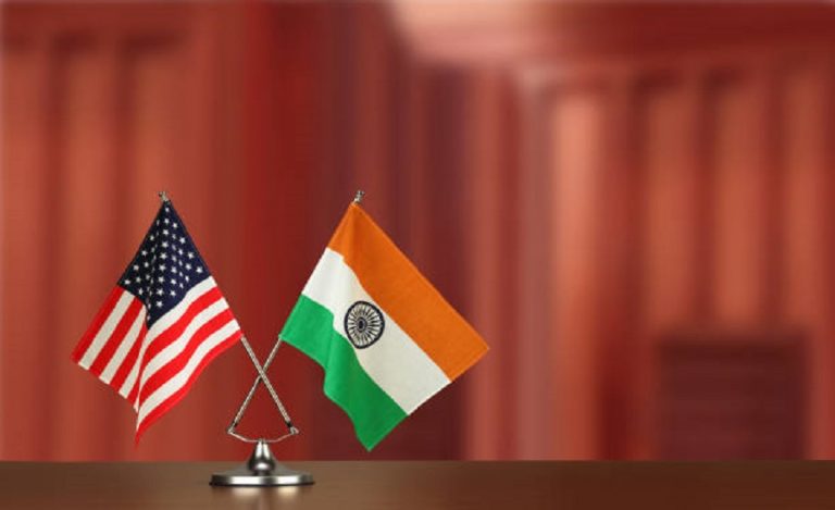 Two crossed national flags on wooden table